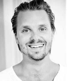 A black and white headshot of Kristoffer Hellstrom