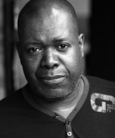 A black and white headshot of actor Geoff Aymer