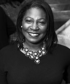 A black and white headshot of actor Landi Oshinowo