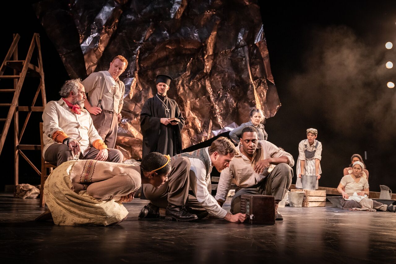 soldiers on stage gathered around a box