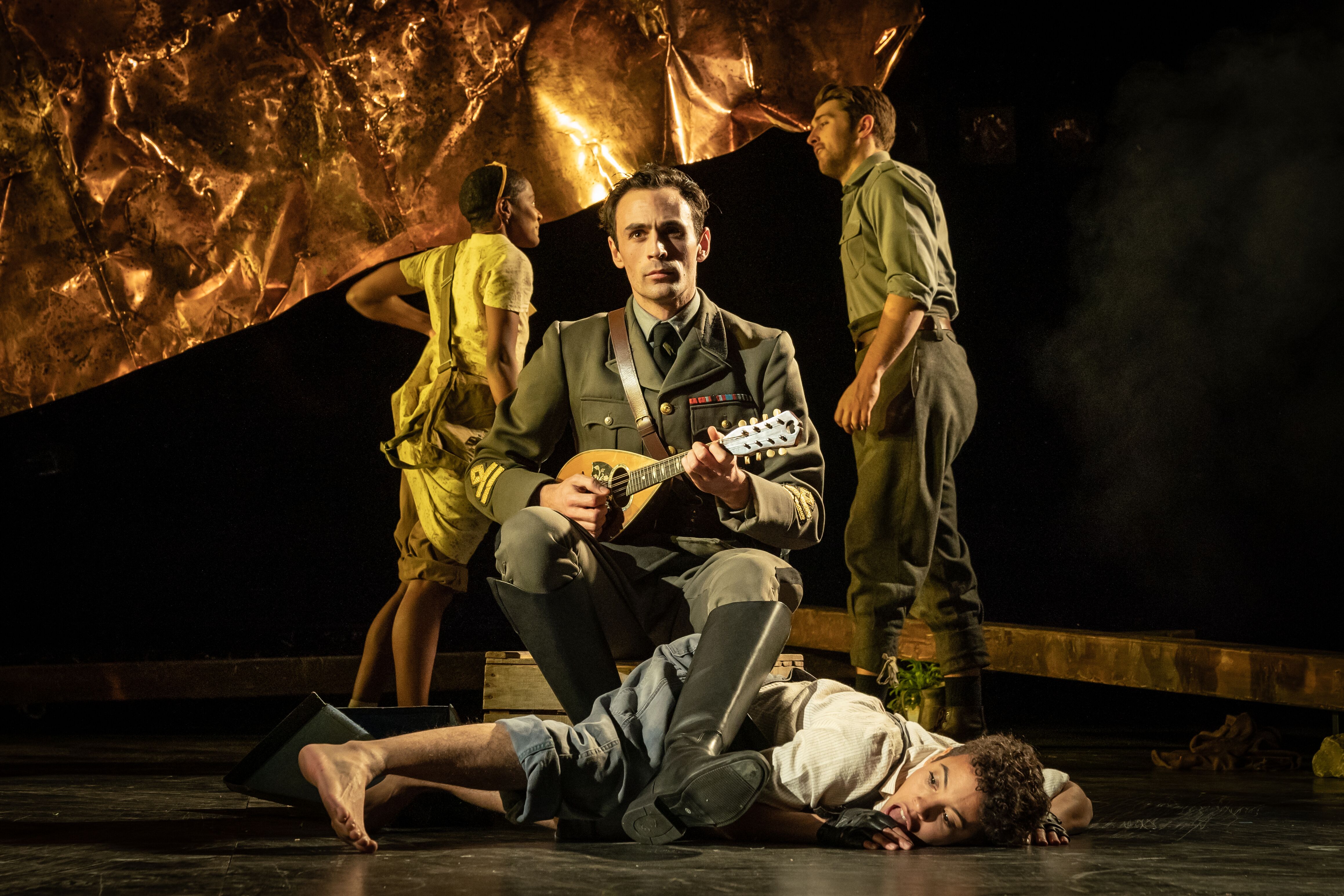 Captain Corelli playing on his mandolin whilst sitting on another cast member