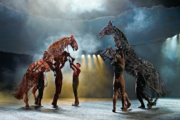 Chesnut and black horse on their hind legs facing one another