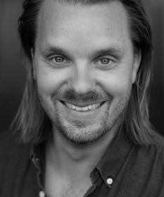 A black and white headshot of Kristoffer Hellstrom