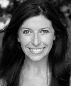 A black and white headshot of Corinna Powlesland