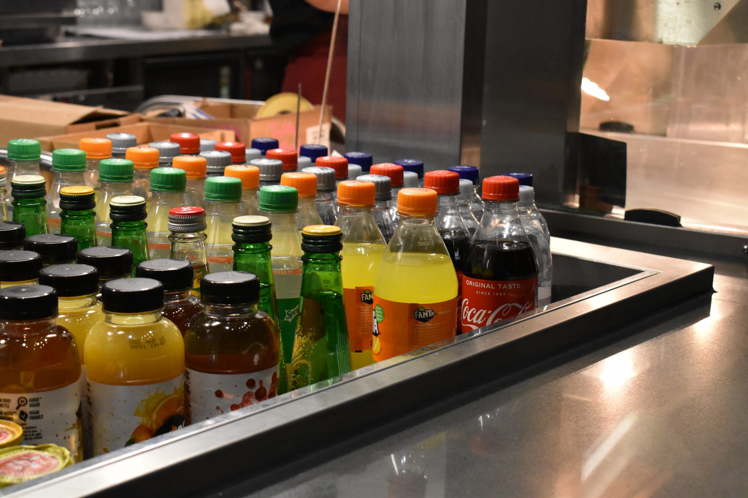 A selection of bottled drinks on a cafe counter.